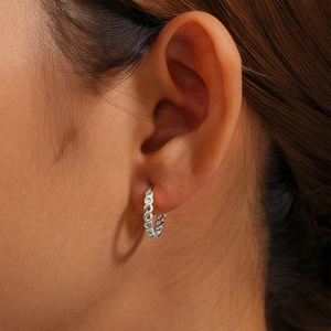 Close-up of S925 sterling silver infinity loop earrings worn by a model