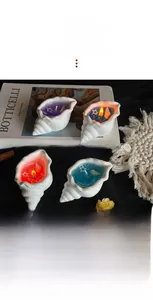 Detailed view of sea shell scented candle with colorful wax and pearl decorations