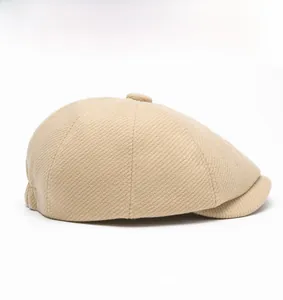 Detailed side view showing the khaki wool blend twill texture and top button of newsboy cap