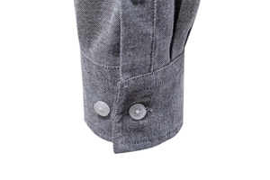 Detail of grey Oxford shirt cuff featuring precise stitching and two white buttons