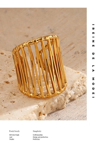 Detailed macro view of 18K gold-plated wide band ring with vertical hollow design