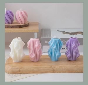 Close-up of geometric spiral scented candles in white pink blue and purple colors