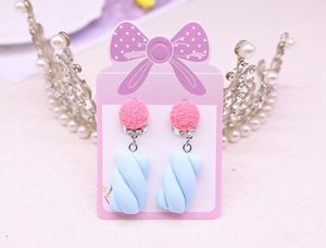 Close-up of cute pink and blue candy-shaped resin clip-on earrings for kids