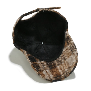 Detail of plaid wool baseball cap showing inner lining and adjustable back strap