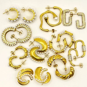 Detail of 18k gold earrings with inlaid white pearls and shimmering high-grade zircons