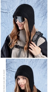 Close-up of black knit trapper hat with ear flaps and soft texture for winter outdoor gear