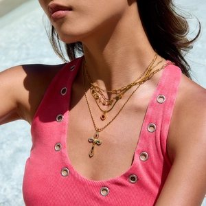 Three-layer gold necklace set featuring heart pendant and colorful gemstone cross charm