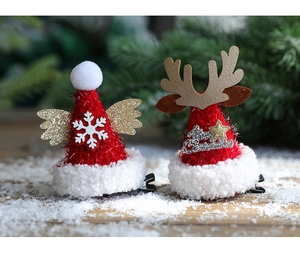 Detail of Christmas reindeer antler hair clips with gold wings and snow decor
