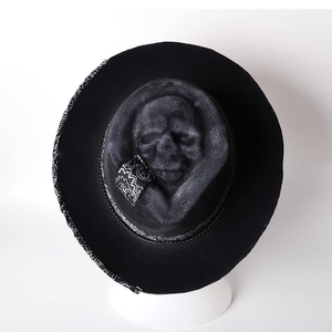 Detailed top view of a felt cowboy hat featuring 3D skull relief and paisley pattern trim