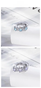 Detail of star hoop earrings with blue and purple cubic zirconia in 925 silver