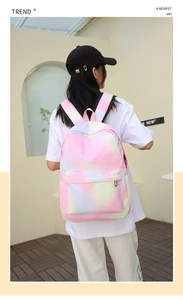 Detail showing the pastel pink blue gradient tie-dye backpack with adjustable black straps