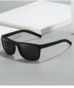 Detail of polarized sports sunglasses with black textured frames and red hinge accents