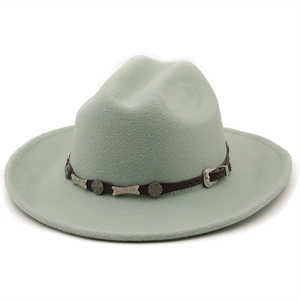 Detail of light green felt cowboy hat with leather band and metal star studs