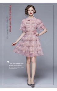 Close-up of pink layered lace cake dress with ruffled Peter Pan collar and elegant details