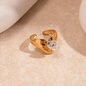 Macro detail of gold lava texture ring band and large heart shaped zircon stone