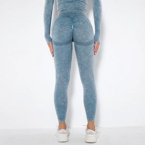 Detail view of high-waist acid wash yoga pants with scrunch butt and breathable mesh holes