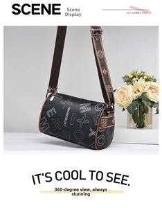 Detail view of black cylindrical Boston bag with textured leather and wide canvas strap