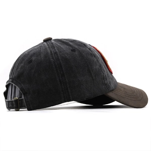 Detail of vintage washed baseball cap showing metal buckle and contrast texture