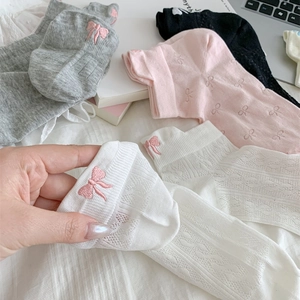 Close-up of breathable mesh cotton socks featuring delicate pink bow embroidery detail