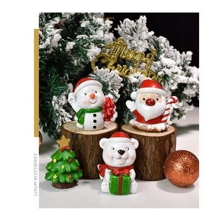 Detailed view of four resin Christmas miniatures including Santa and Snowman on wood base