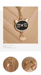 Close-up of khaki textured leather bag with V-quilt stitching and gold cat charm