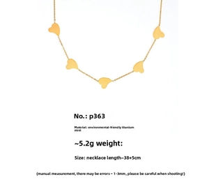 Macro detail of 18k gold plated titanium steel necklace with five heart charms