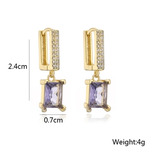 Detail showing 2.4cm long gold geometric earrings with rectangular purple zircon stone