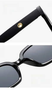Macro detail of curved black temple with gold ring inlay and integrated nose pads
