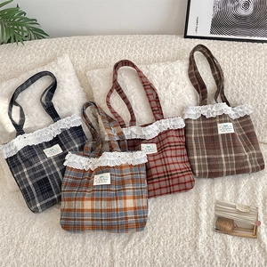 Flat lay of plaid tote bags with white lace trim in four different checkered patterns