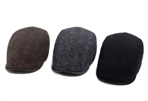 Detailed view of herringbone wool caps in brown, gray and black colors with fine textures