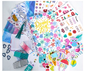 DIY journal set detail with spiral notebook, decorative stickers, washi tapes and clips