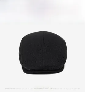 Detail view of the high-quality black wool texture and fine twill on the men's flat cap