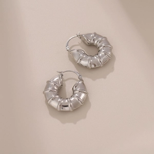 Polished silver stainless steel hollow bamboo earrings with textured hoop design