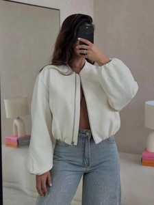 White long sleeve bomber jacket and high waisted rhinestone skinny jeans outfit