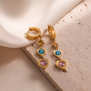 Gold-plated heart drop earrings with pink and blue zircons and pearls on silk background