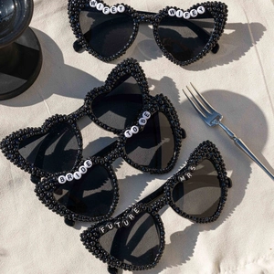 Black heart-shaped sunglasses with Bride and Wifey pearl lettering for bridal parties
