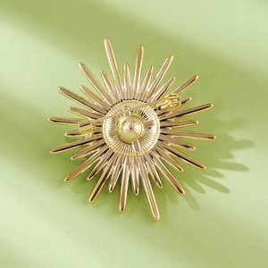 Close-up of golden sunflower brooch showing steady pin clasp on the back of the alloy