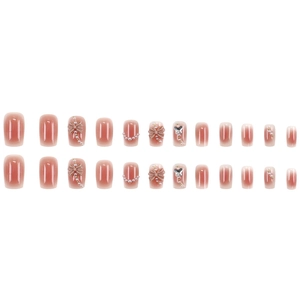 Pink ombre press-on nails set with 3D bows and pearls on a clean white background