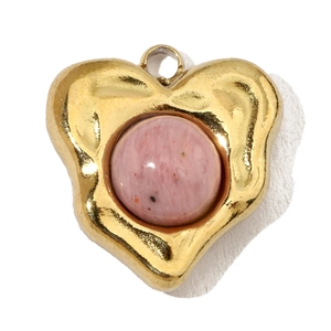 Detail of a heart-shaped gold pendant with an inlaid pink natural stone cabochon