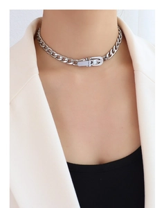 Close-up of a silver thick chain choker necklace with a belt buckle clasp for women