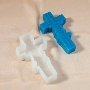 Detail of cross silicone mold with 'Faith' engraved blue resin candle piece