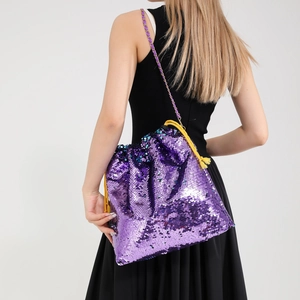 Detail of purple sequin bucket bag featuring golden chain and yellow drawstring closure
