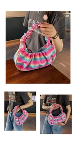 Detailed view of rainbow gradient pleated handbag with scrunchie style handle and silk finish