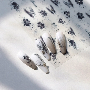 Ink butterfly and floral embossed nail stickers with sparkling rhinestones on marble