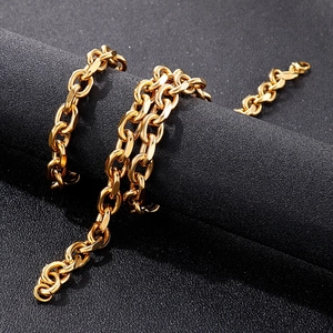 Polished gold flat O-chain stainless steel necklace set for men on black textured background