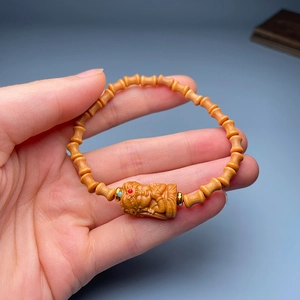 Detailed texture of sandalwood prayer beads with a finely carved wooden pendant