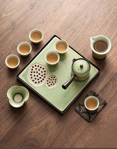 Top view of green ceramic tea set with ice-crackle glaze on lotus root tray