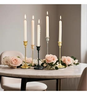 Close-up of elegant gold, silver and black metal candlesticks on marble table
