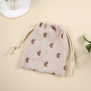 Detail of cotton muslin drawstring bag with brown rainbow print for baby items