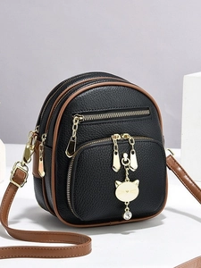 Mini black lychee leather backpack with golden hardware and cute cat charm decoration